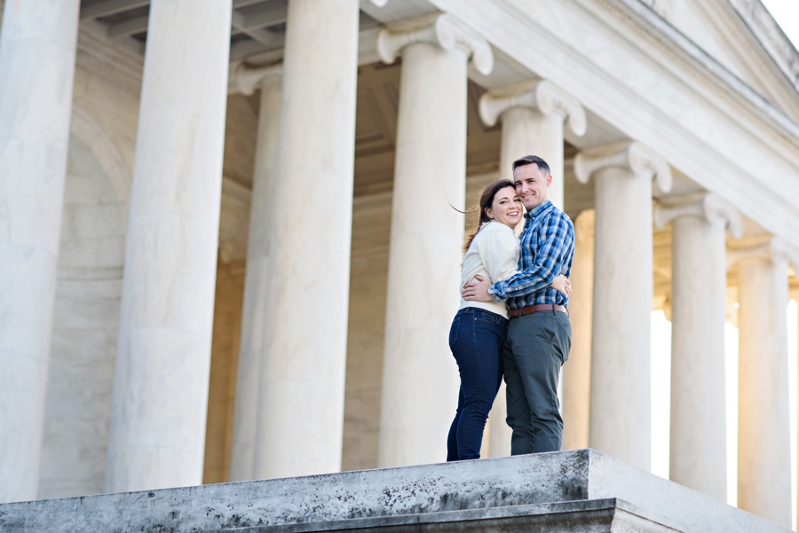 A navy couple pose in front of the lincoln memorial for their DC engagement session.